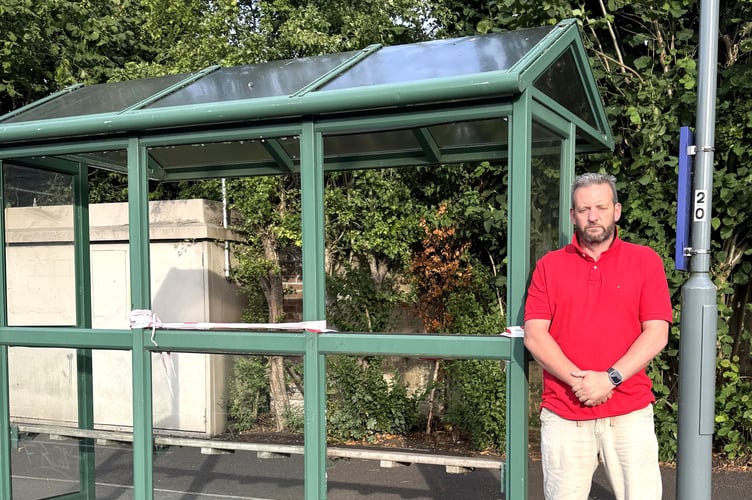 Cllr Gavin Heathcote next to one of the vandalised bus shelters in Orchard Way, Peasedown St John.
