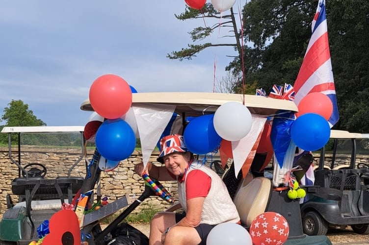 Lady Captain Susan Marshall on her buggy festooned with balloons, poppies and a ukulele.