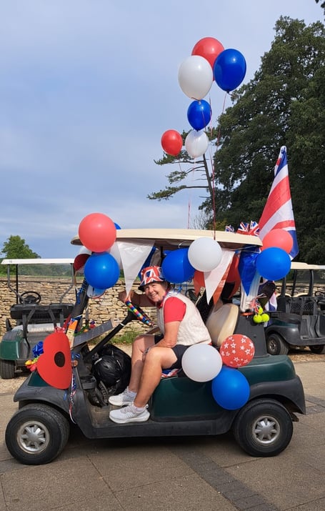 Lady Captain Susan Marshall on her buggy festooned with balloons, poppies and a ukulele.