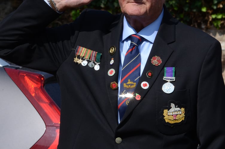 Veteran Chris Copeland is pictured saluting the fallen during the service at the High Street Cenotaph 
