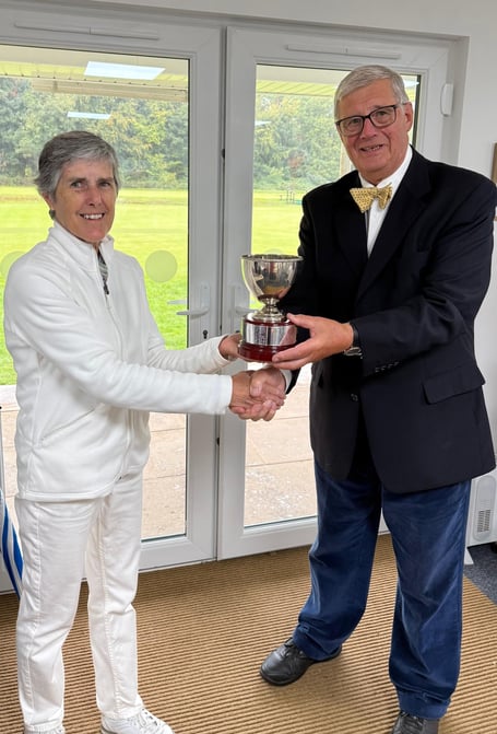 Brian Wilson, representing Croquet England and Camerton and Peasedown CC, presenting the silver cup to tournament winner Fiona Walker.