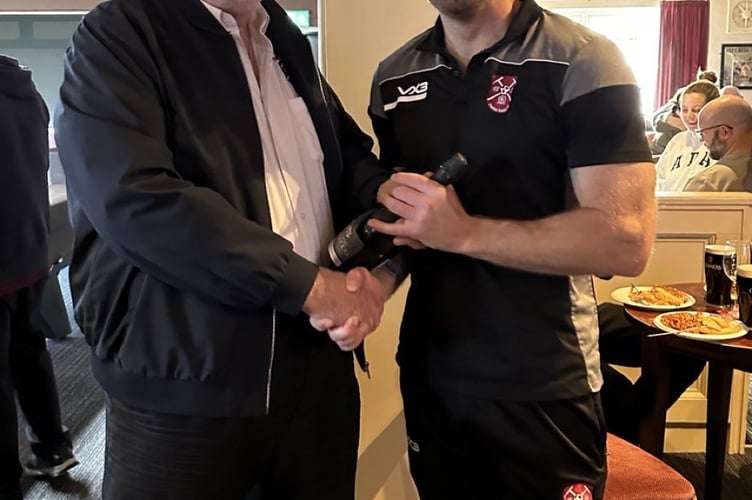 Paulton Rovers player of the match Chris Peck receives his award sponsored by VIATEC LIMITED of Westfield from Football Chairman Dave Bissex.