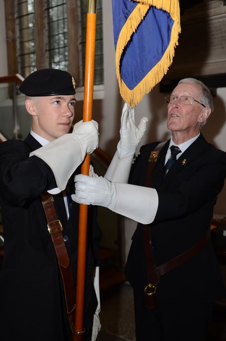 Aiden is pictured under instruction from John Gallop, the Somerset County Royal British Legion Standard Bearer