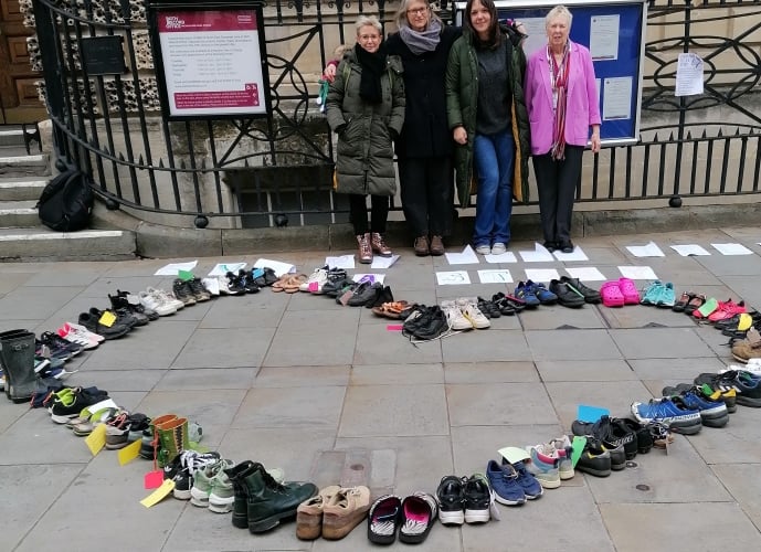 Leanna Biggs, Emily Jolliffe, Louise Prior with Cllr Lesley Mansell with the display of shoes outside the Guildhall Bath