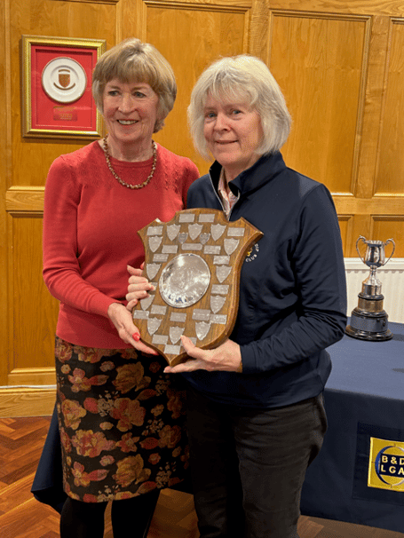 The Alliance A team captain Marion Speed (right) receives the trophy for winning Division 2 of the Bristol & District Alliance. 