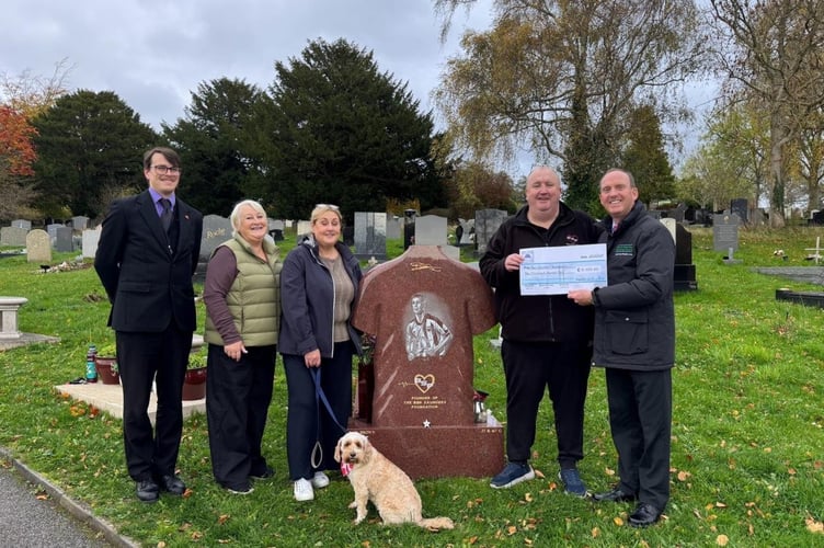 Karen Payton, Ben’s aunt and trustee (middle left), Joanne Saunders, Ben’s mother and trustee (middle) and Tom Saunders, Ben’s father and trustee (middle right) pictured with family dog Mabel and Haycombe staff at Haycombe Cemetery