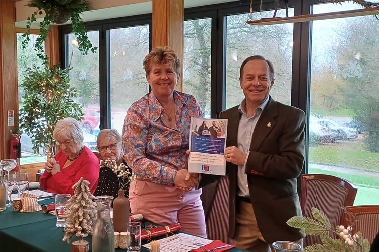 Susan Marshall being presented with a certificate by Richard Asprey for raising almost £1,300 for the Royal British Legion.