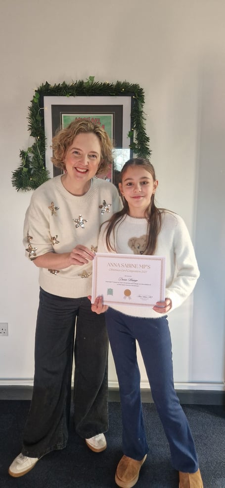Winner of the Christmas card competition Daria Strango of Selwood, pictured with MP Anna Sabine