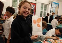 Candles light up the night sky to mark future woodland