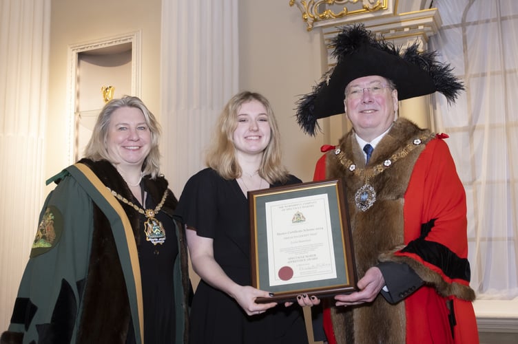 Specsavers apprentice Leila Hamilton being presented with her fellowship award. 