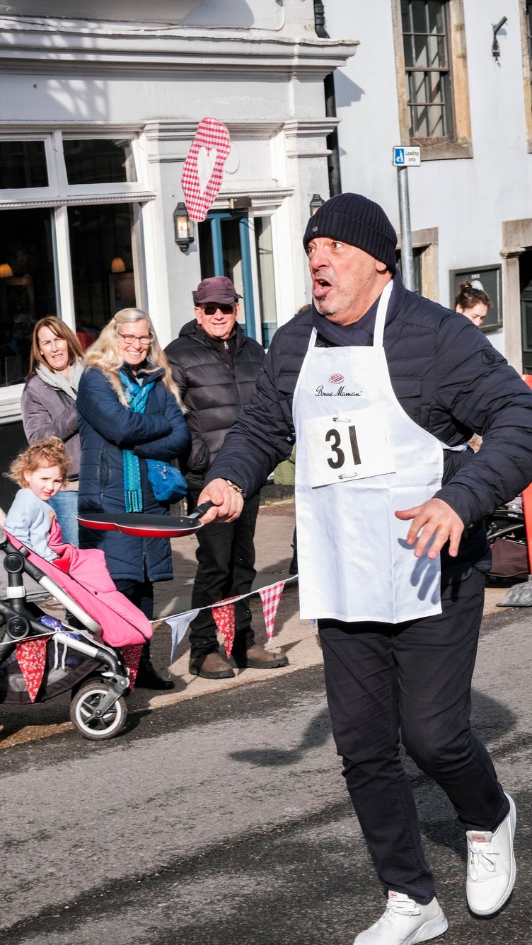 Contestants dashed along the course flipping their fabric pancakes in heart-shaped pans.