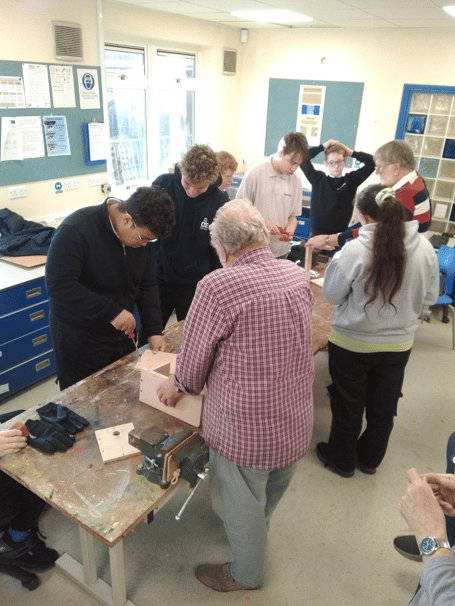 Midsomer Norton Man Shedders assist pupils from Fosse Way School on a bird box project.