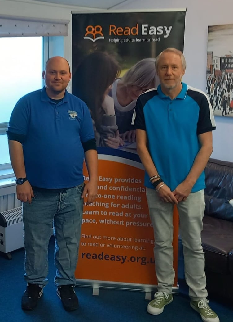 Graduates Roger and Gary celebrating their newly acquired reading skills with Read Easy Bath.