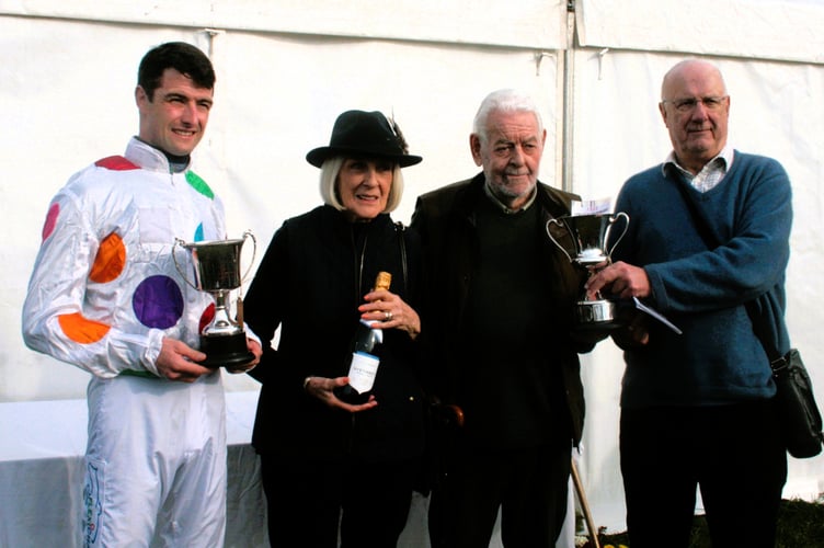 Jockey James King receiving trophy from Kath and Roger Penny of Litton with owner of Jewel of Windsor