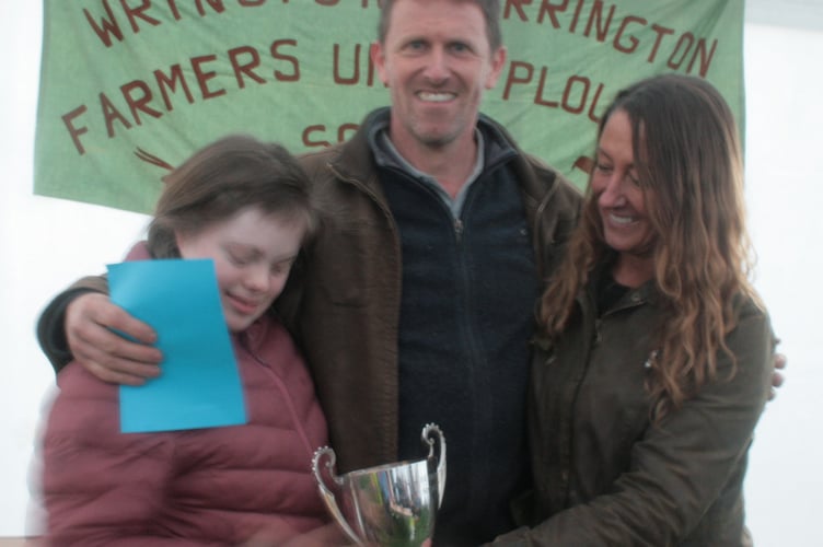 Champion Colin Clutterbuck receiving his Champion's cup from Jo Vowles.