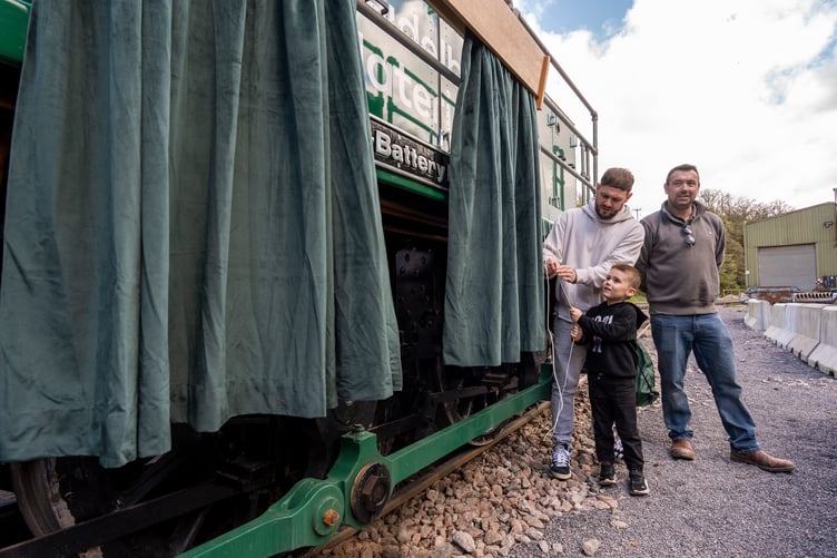 Schoolboy Cillian Gallagher unveiling the name of Battery Bill he chose for the new locomotive at Whatley Quarry.