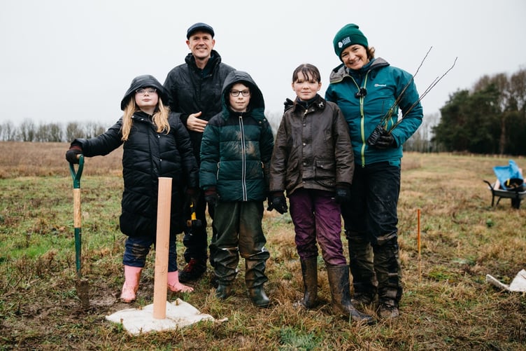 Luke Jerram plants the first trees of Echo Wood with local school children.