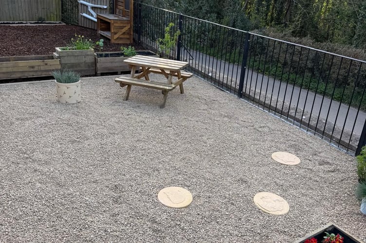The garden area has been transformed to include new paving, wooden planters and a personalised bench and outdoor play area. 