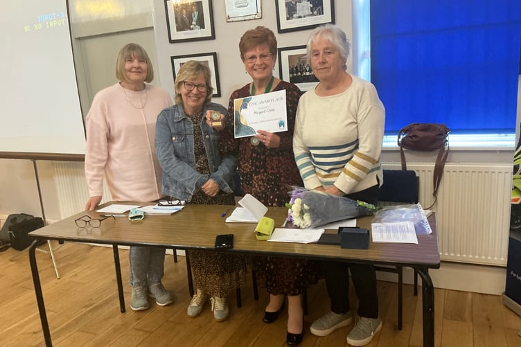 Margaret Crane share her Lifetime Achievement Award trophy and certificate with committee members of the Redfield Road Wives Group.