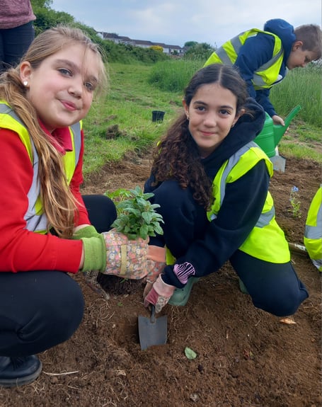 Pupils from Westfield Primary School Garden Club get stuck into some planting at Waterside Valley Park.