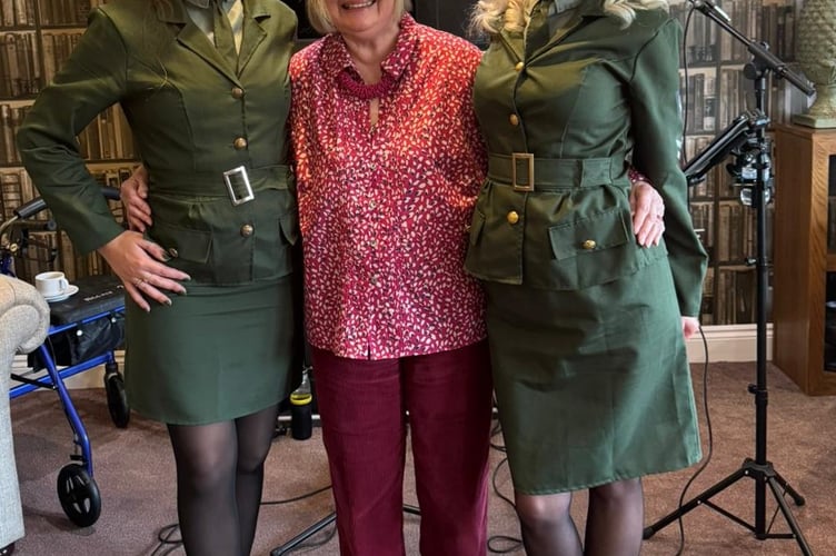 The D-Day Dollies, here with a Crandon Springs Care Home resident, entertained with wartime-themed songs.