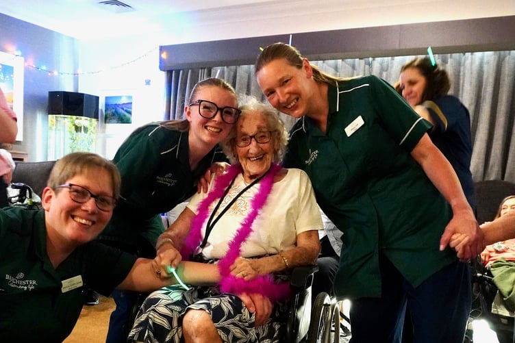 Resident Margaret, enjoying the disco at Crandon Springs with some of the care staff.