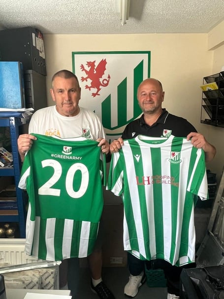 Mike Rogers, of Welton's Green Army, presents manager Wayne Thorne with this season's new kit before the game against Shirehampton.