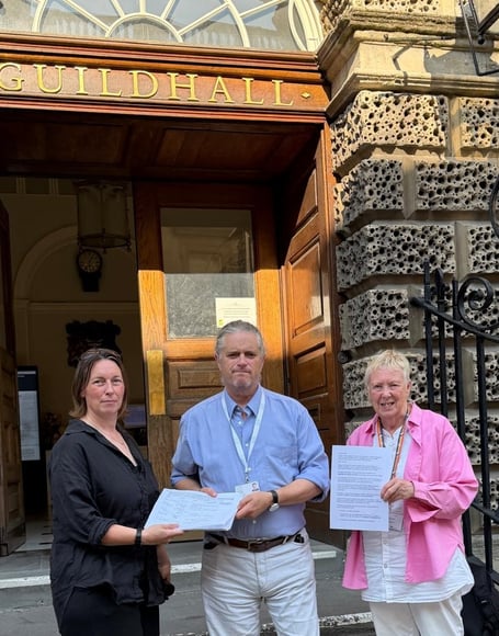 Resident and councillor hand petition to B&NES cabinet member to reinstate field in conservation area.