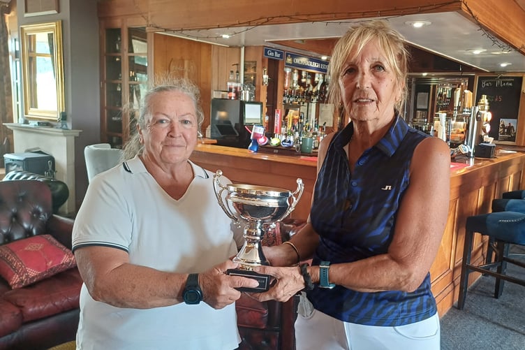 Rachel Priddle (left) receiving the Sally Lock Trophy from Lady Captain Jan Light