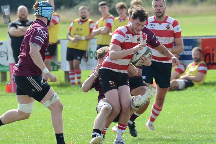 Midsomer Norton (red hoops) in action against Cleve