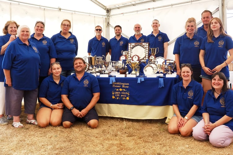 The show committee proudly wearing new polo shirts which display the new logo based on a medal design.