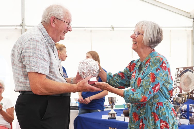 Angus Hopper being presented with the Glass Bowl for best floral art exhibit by president Mrs Hilary Denning.